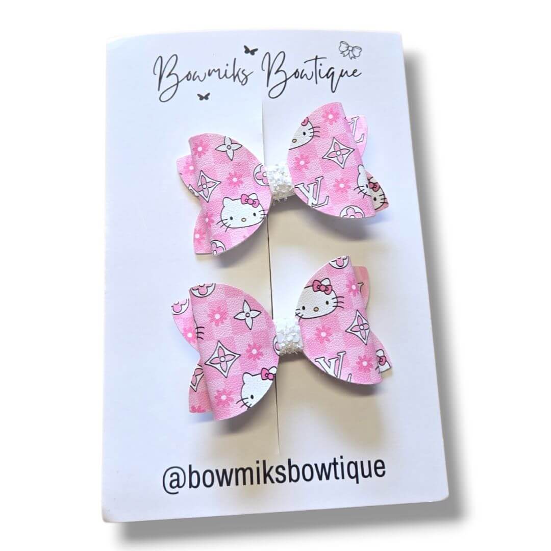 Bowmiks Boutique handmade hair accessories, featuring pink Hello Kitty bow clips, perfect boutique hair accessories for kids.