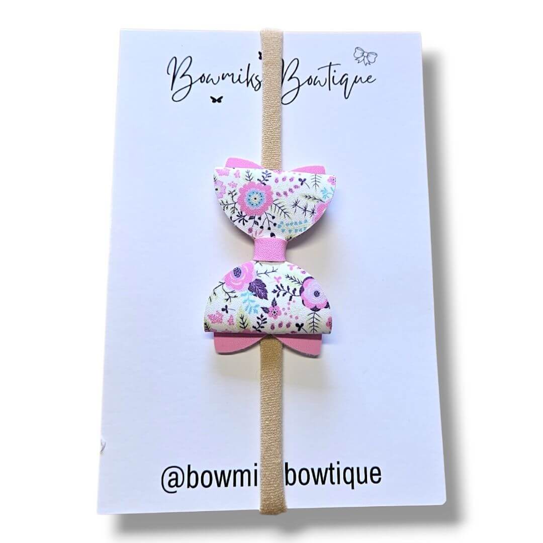 Boutique hair accessories for kids - colorful floral bow clip from Bowmiks Boutique on a stylish card.
