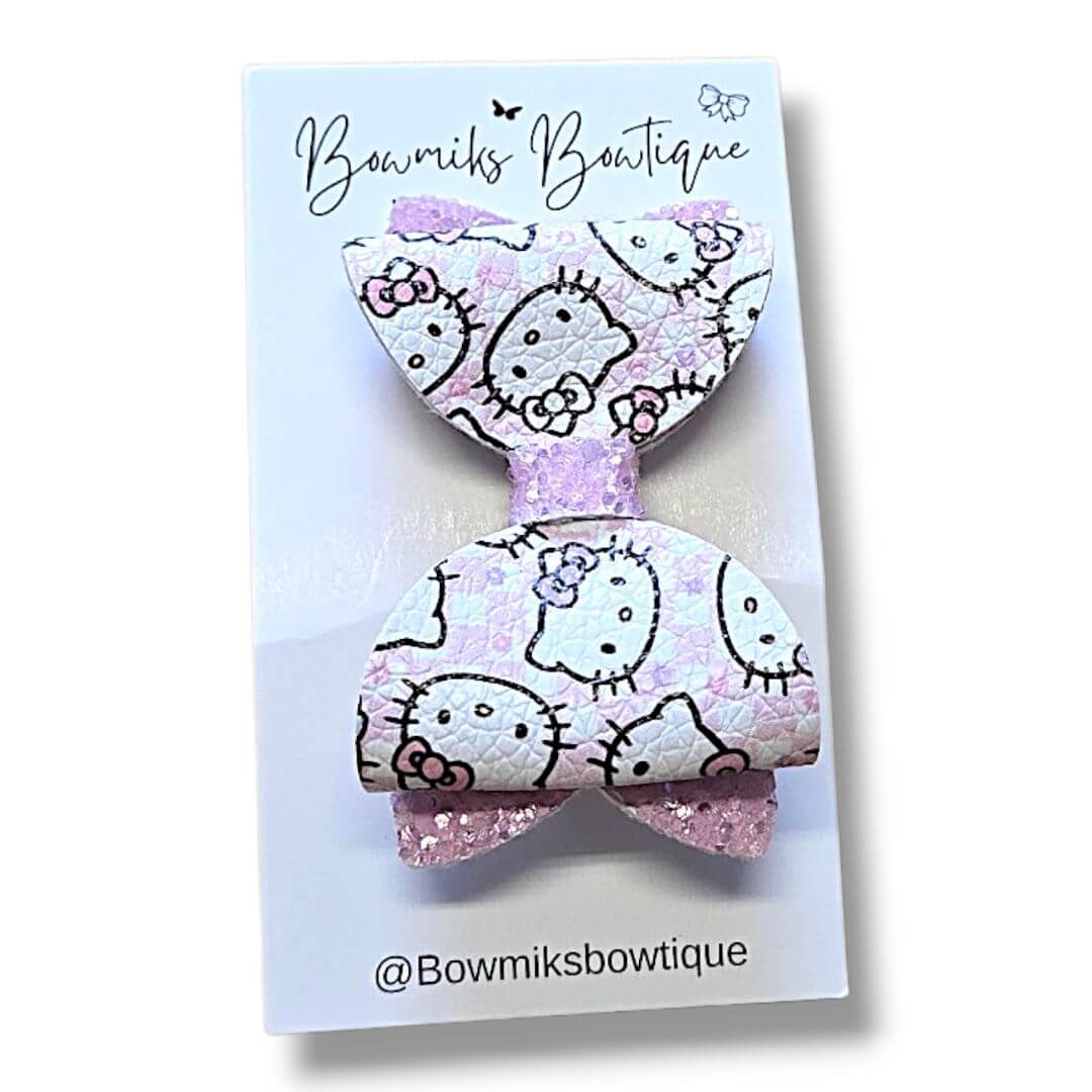 Boutique hair accessories for kids featuring a Hello Kitty bow clip in pink and white.