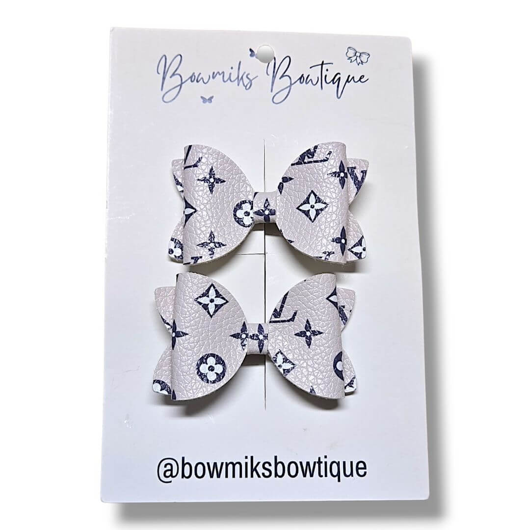 Boutique pigtail bow clips in stylish gray with navy patterns from Bowmiks Boutique, perfect for any outfit.
