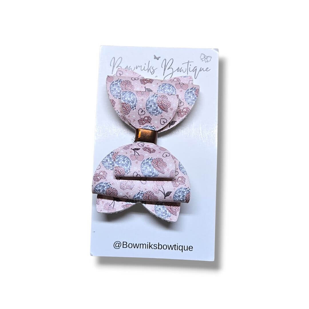 Handmade double layer bow clip by Bowmiks Boutique, featuring a cute design with hearts and flowers.