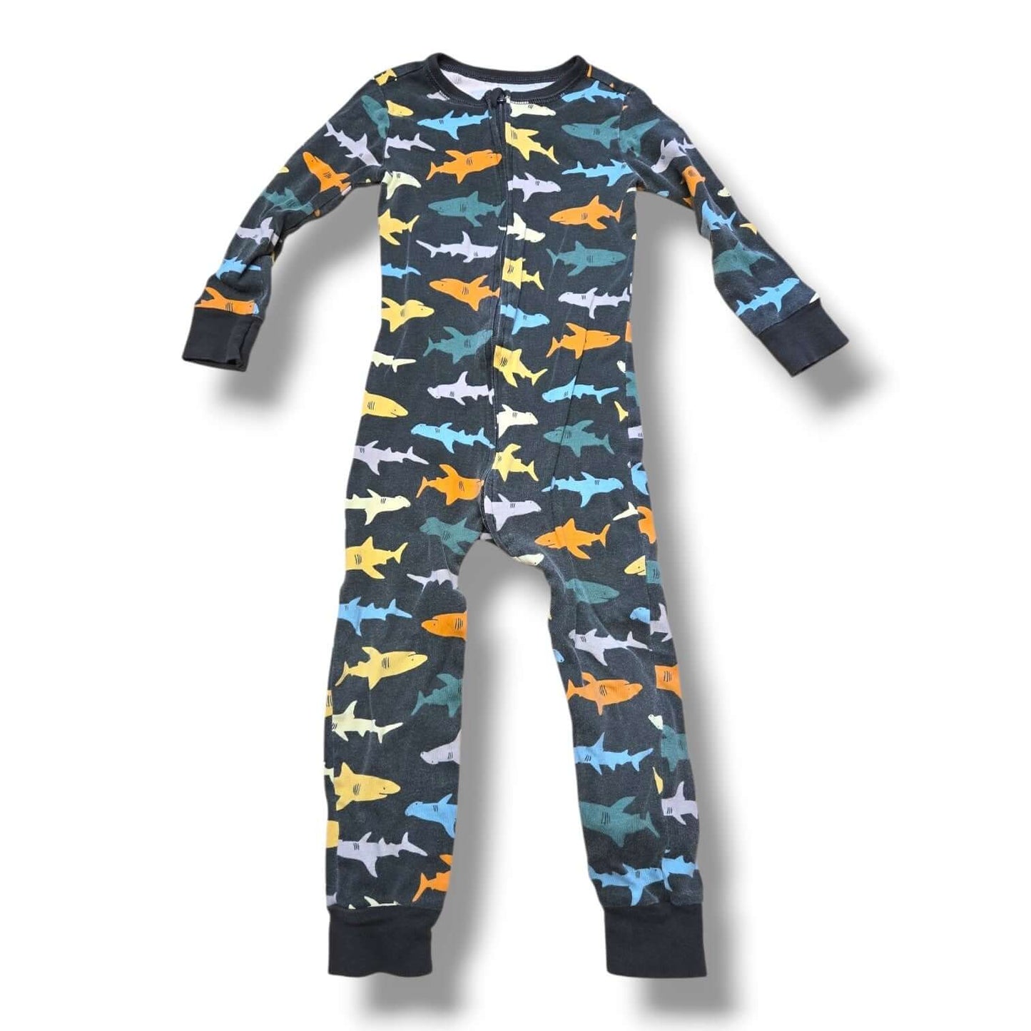 Pre-loved 3T sleeper featuring colorful shark patterns for kids, ensuring cozy comfort.