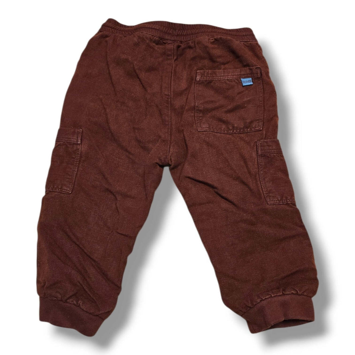 Back view of pre-loved Zara cargo joggers in rust brown color with elastic waistband and cargo pockets.