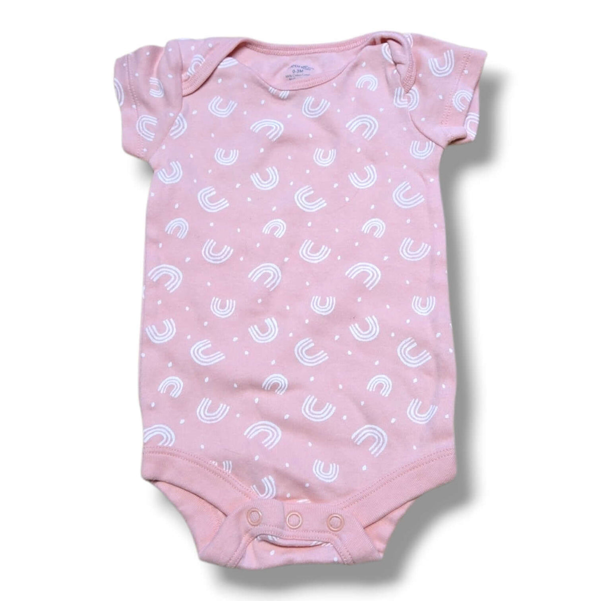 Pre-loved baby onesie in soft pink with white rainbow pattern and snap closures for easy changing.