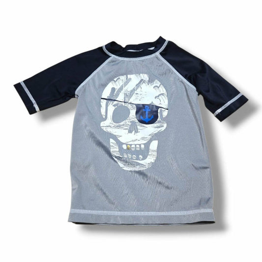 Pre-loved children's swim top featuring a pirate skull design and navy sleeves, perfect for beach adventures.