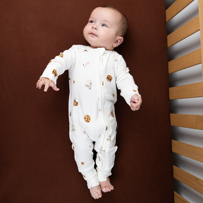 Baby wearing a ribbed bamboo footless sleeper with a milk and cookies print, perfect for cozy holiday moments.