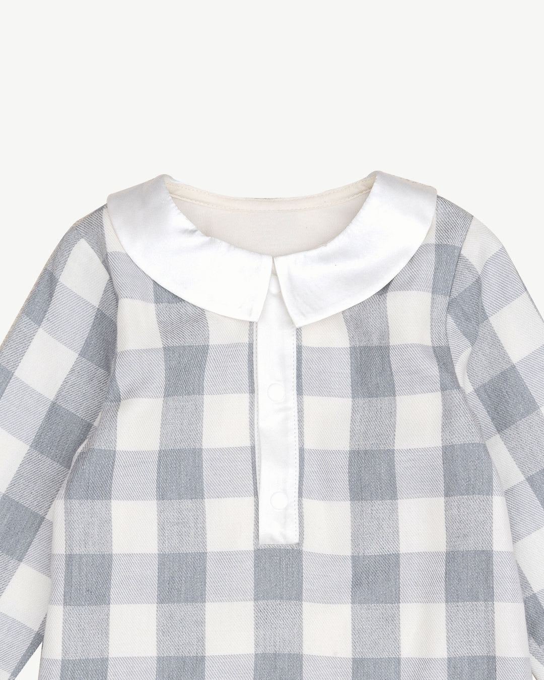 organic cotton checker bodysuit featuring a classic collar and snap closures for easy dressing.
