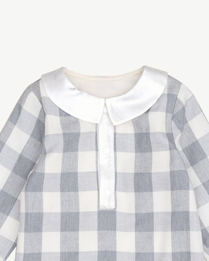organic cotton checker bodysuit featuring a classic collar and snap closures for easy dressing.