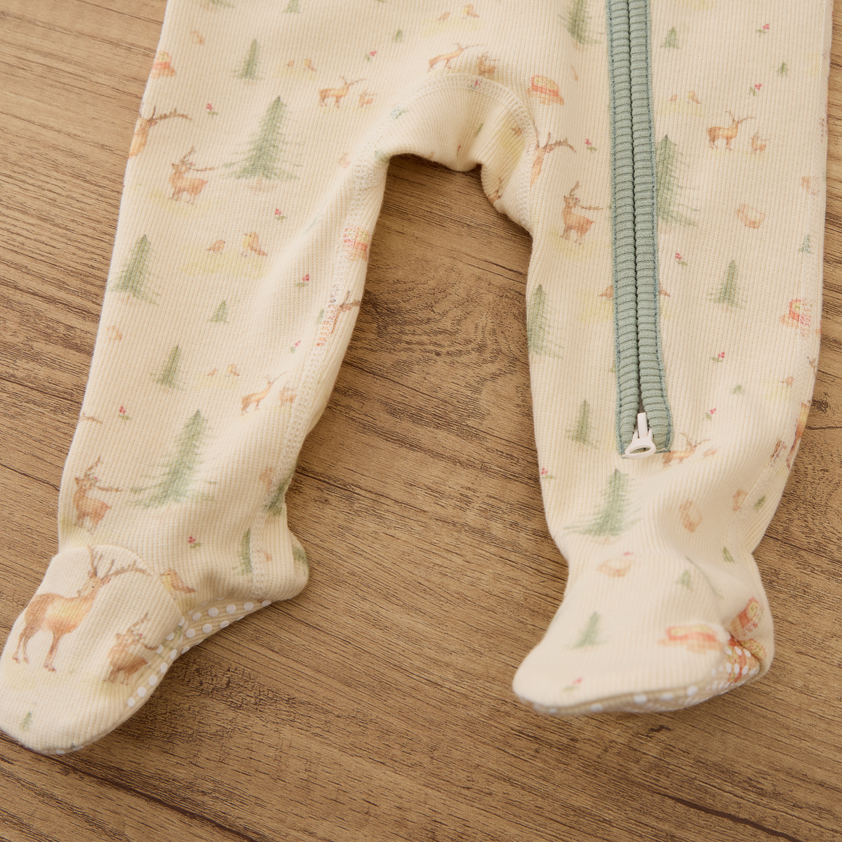 Close-up of Blara Organic House organic cotton footie romper with footies and zipper detail.