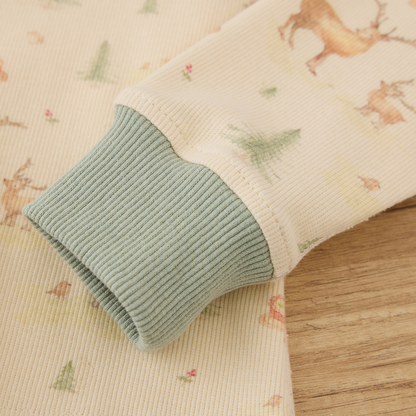 Detail of Blara Organic House organic ribbed henley pajama set showing ribbed cuffs and playful floral pattern.