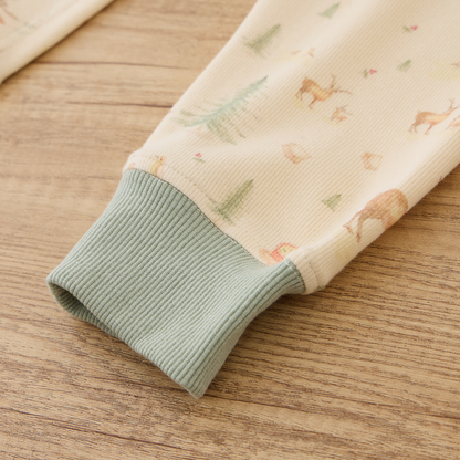 Close-up of ribbed cuff from Blara Organic House organic ribbed henley pajama set on wooden surface.