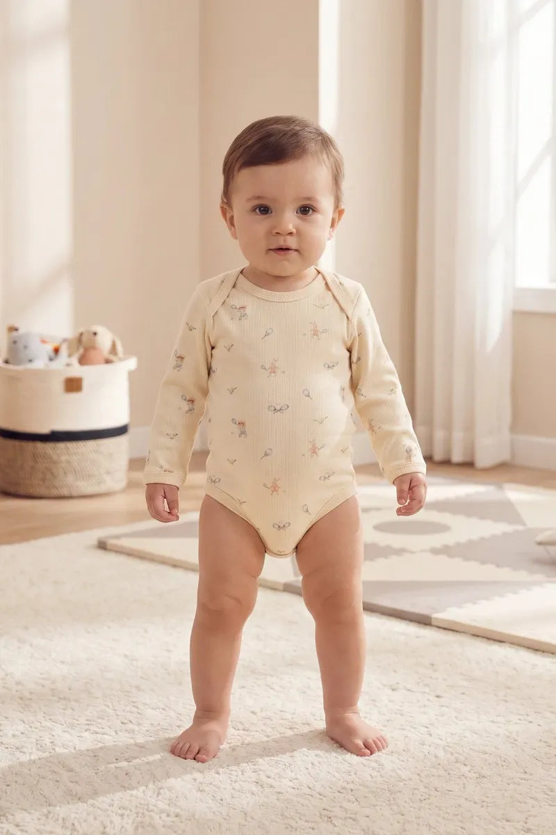 Baby wearing an organic cotton bodysuit from the organic cotton baby gift set, standing in a bright, cozy room.