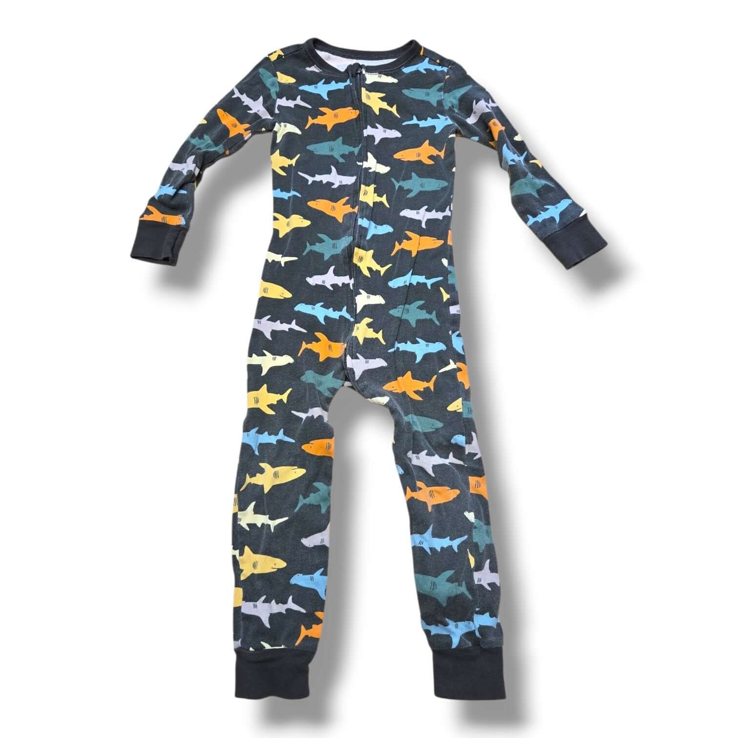 Pre-loved 3T sleeper featuring colorful shark patterns for kids, ensuring cozy comfort.