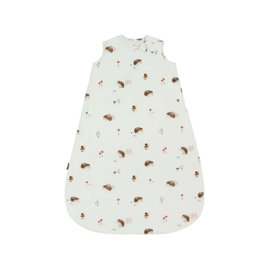 Hedgehog sleep sack with whimsical print of hedgehogs and mushrooms on a soft white background.