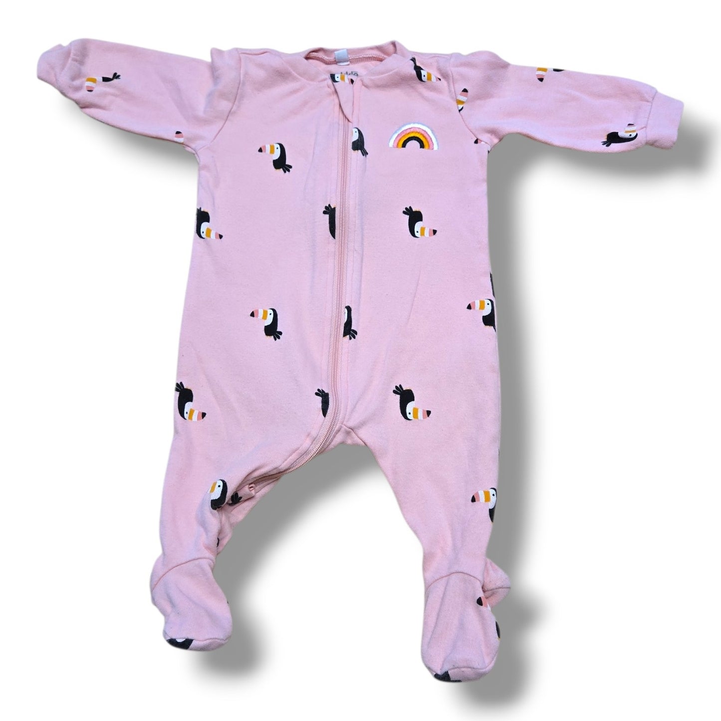 Pekkle pre-loved baby sleeper in size 3 months with toucan print and rainbow detail on pink background.