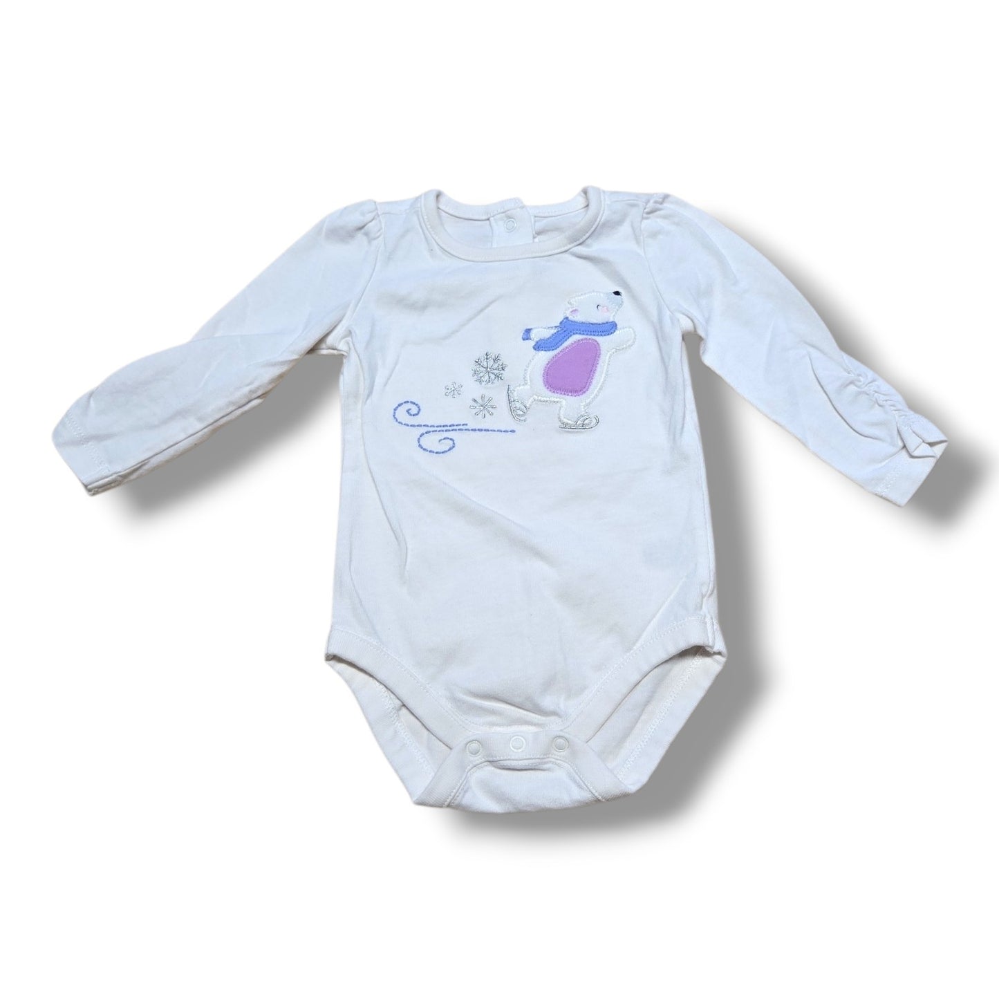 Preloved baby onesie featuring a cute polar bear design, perfect for layering or everyday wear.