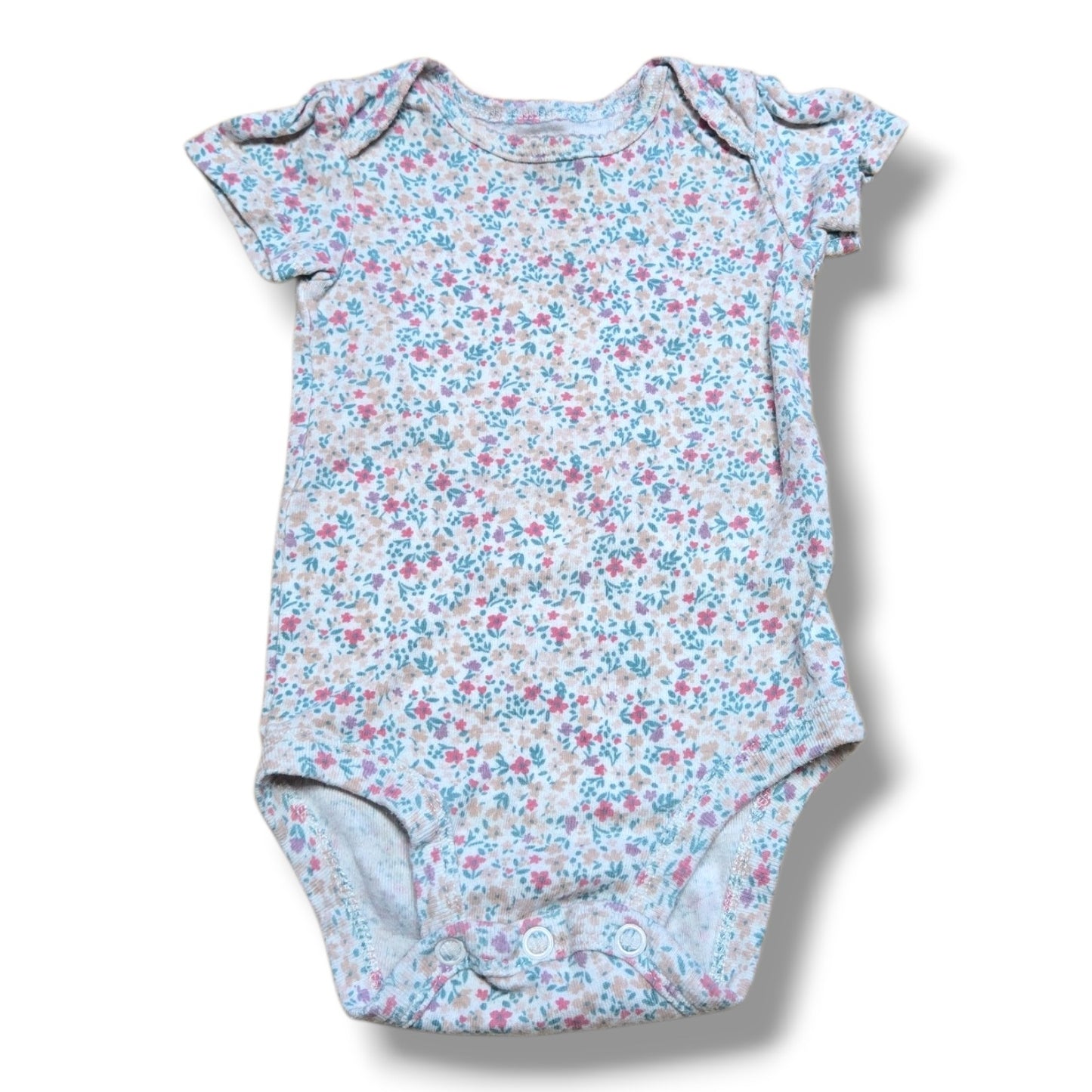 Pre-loved baby onesie with floral pattern, soft fabric, perfect for layering and everyday wear.