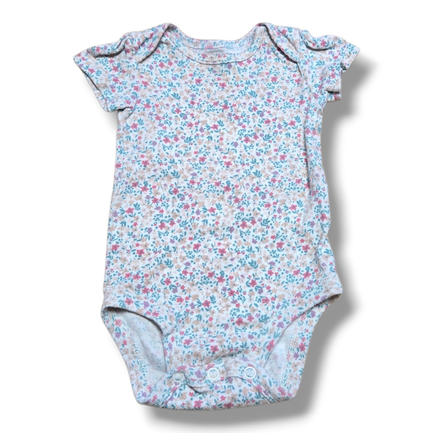 Pre-loved baby onesie with floral pattern, soft fabric, perfect for layering and everyday wear.