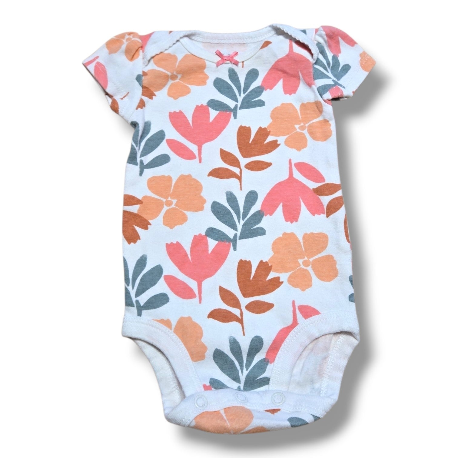 Preloved infant onesie with floral design, perfect for layering and everyday wear for your little one.