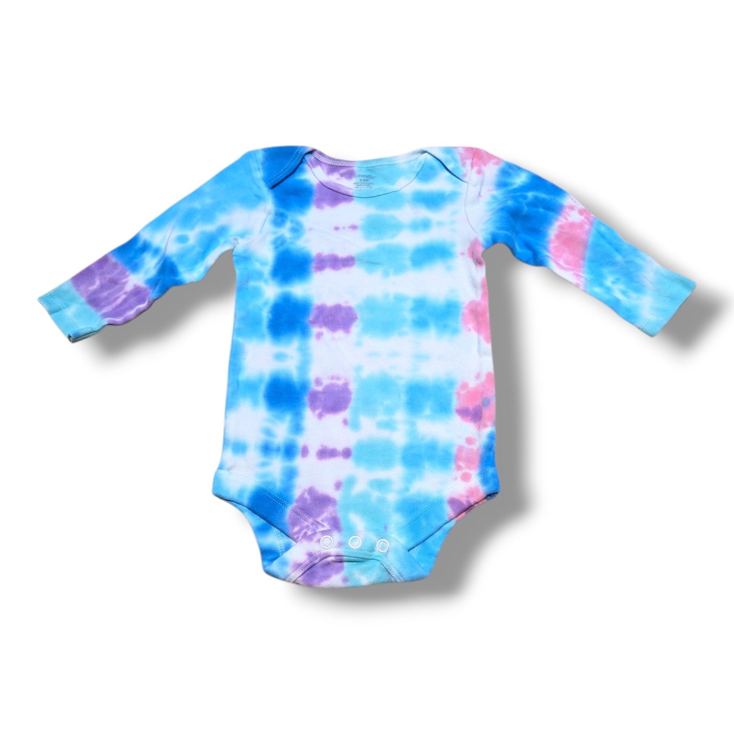 Pre-loved baby onesie in vibrant tie-dye colors, perfect for everyday wear and comfort.