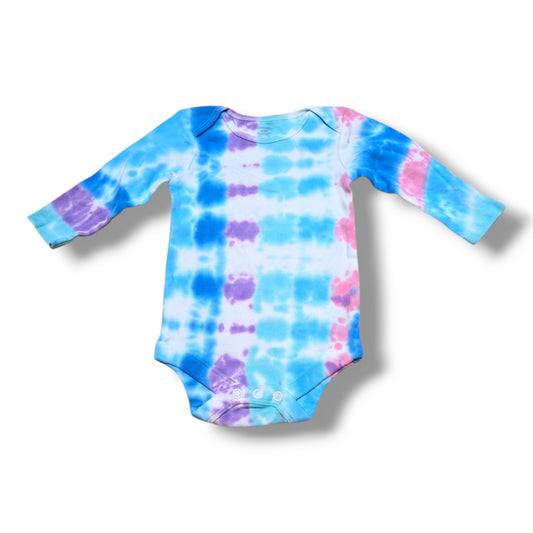 Pre-loved baby onesie in vibrant tie-dye colors, perfect for everyday wear and comfort.
