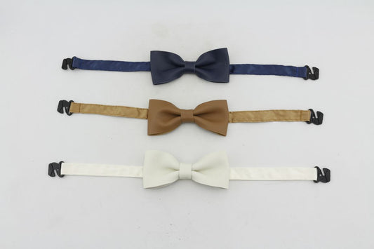 Three baby leather bow ties in navy, tan, and white with adjustable straps for a perfect fit.