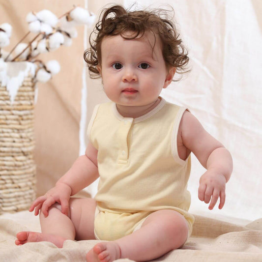 Organic cotton sleeveless baby bodysuit in creamy yellow, perfect for warm weather and comfort.