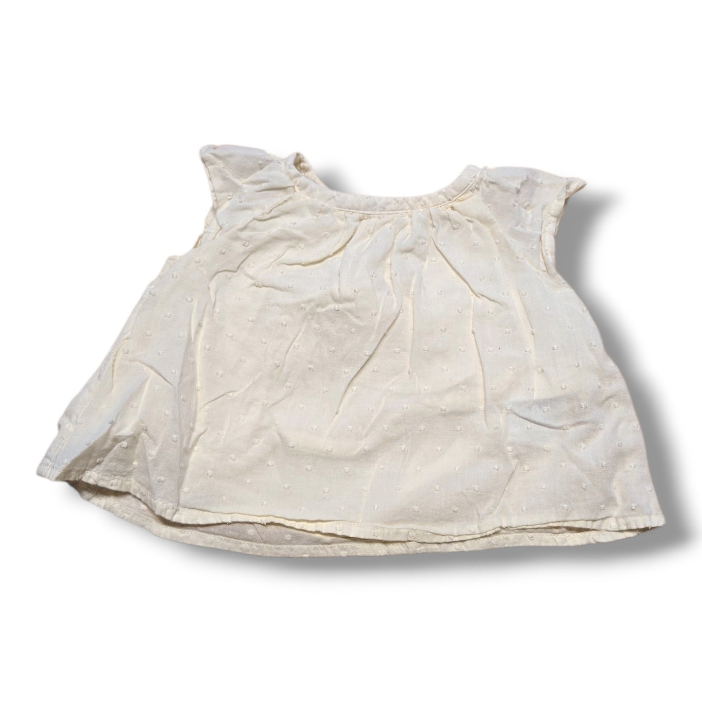 Old Navy preloved baby t-shirt 3-6 months in cream with flutter sleeves and Swiss dot fabric.