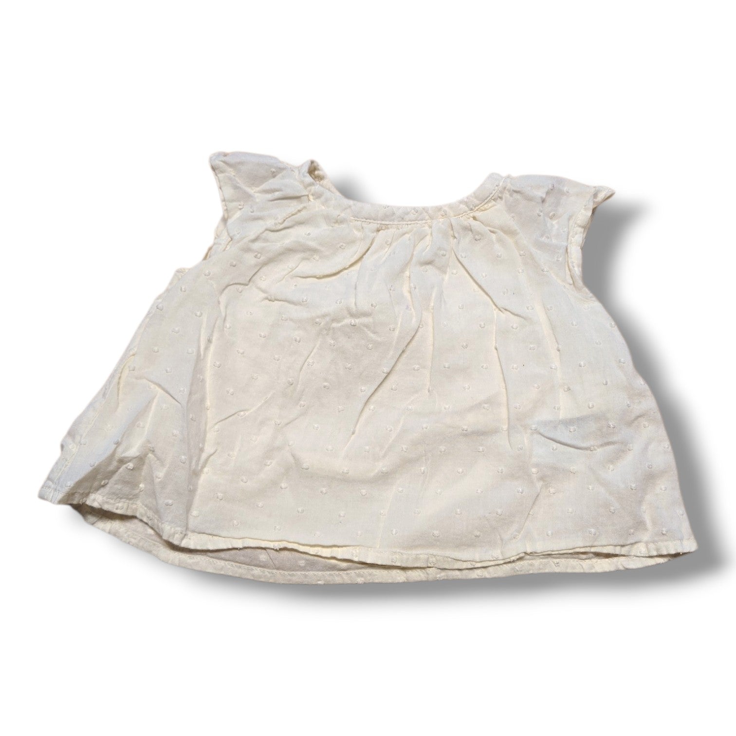 Old Navy preloved baby t-shirt 3-6 months in cream with flutter sleeves and Swiss dot fabric.