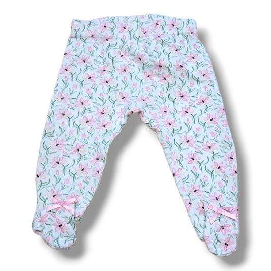 Pre-loved baby pants 3-6 months with floral print, built-in feet and pink bow details, in mint condition.