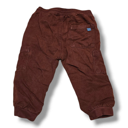 Back view of pre-loved Zara cargo joggers in rust brown color with elastic waistband and cargo pockets.