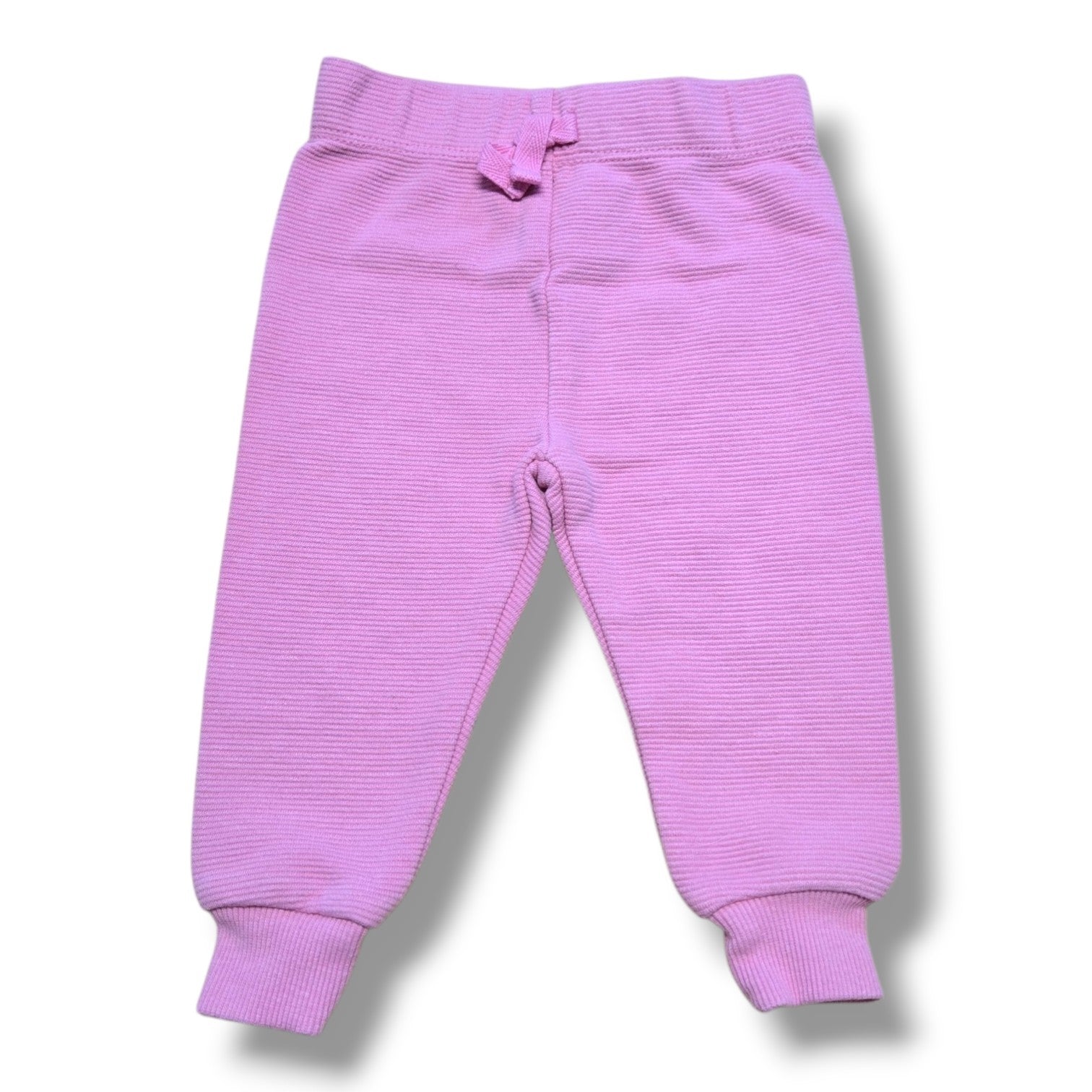Pre-loved Disney joggers in soft ribbed knit, size 3 months, with comfy elastic waistband and cuffed ankles.