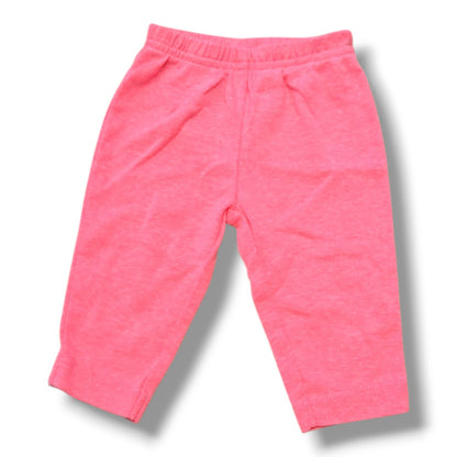 Soft pink knitted preloved baby pants for infants in size 0-3 months with comfortable elastic waistband.