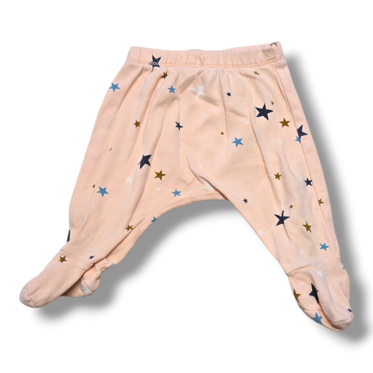 Pre-loved baby pants 0-3 months in soft pink with star print and built-in feet.