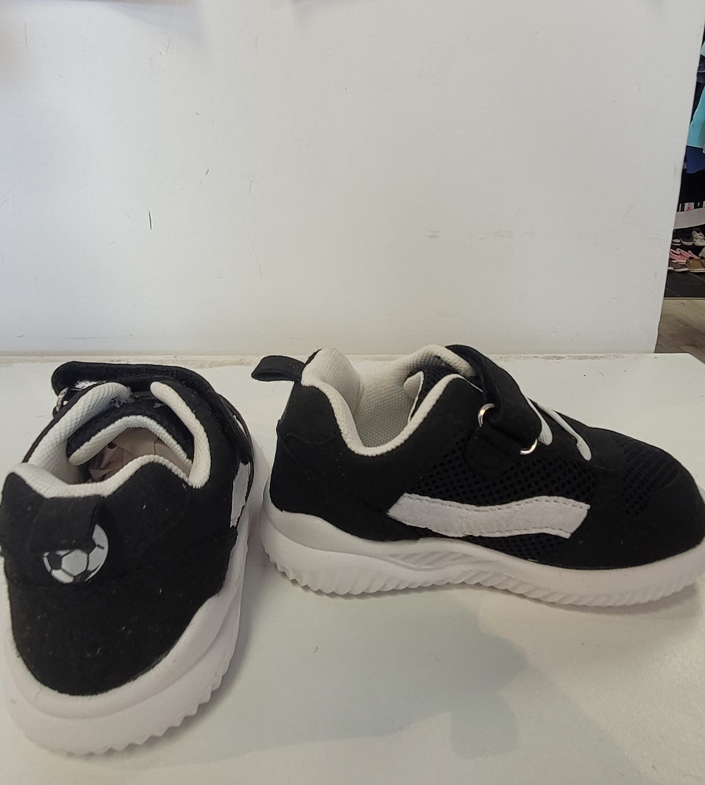 Lightweight EVA sneakers for kids in black and white, perfect for active children.