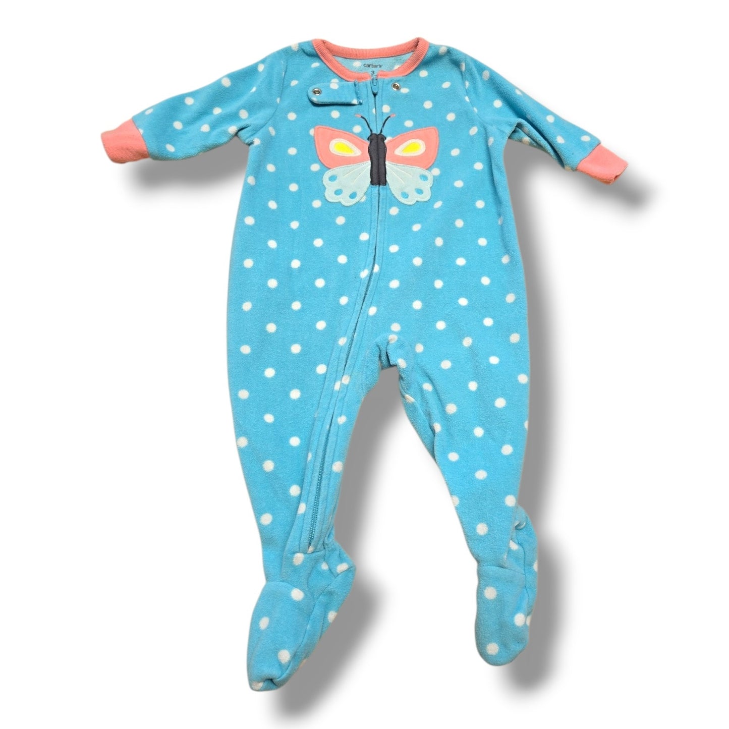 Pre-loved fleece sleeper for toddlers with butterfly design and polka dots, perfect for cozy moments.