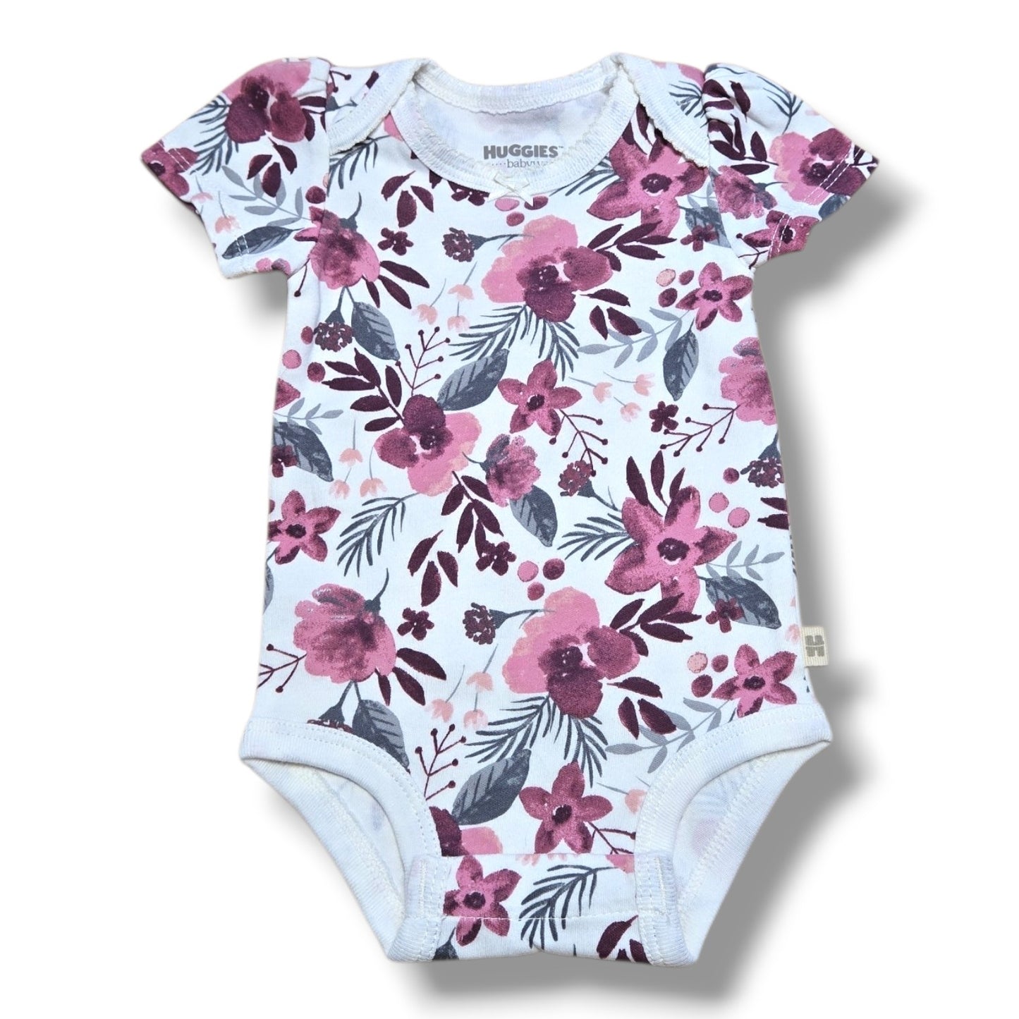 alt_tag: Huggies baby onesie in floral print, soft pre-loved baby onesie in mint condition, perfect for newborns.