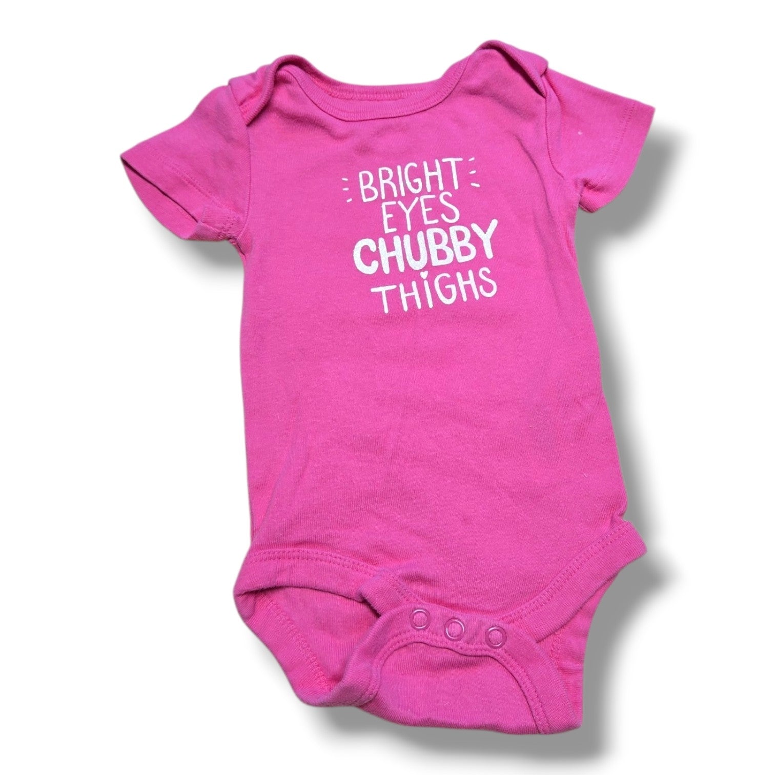 Bright pink pre-loved baby onesie with the phrase "Bright Eyes Chubby Thighs" for little ones.