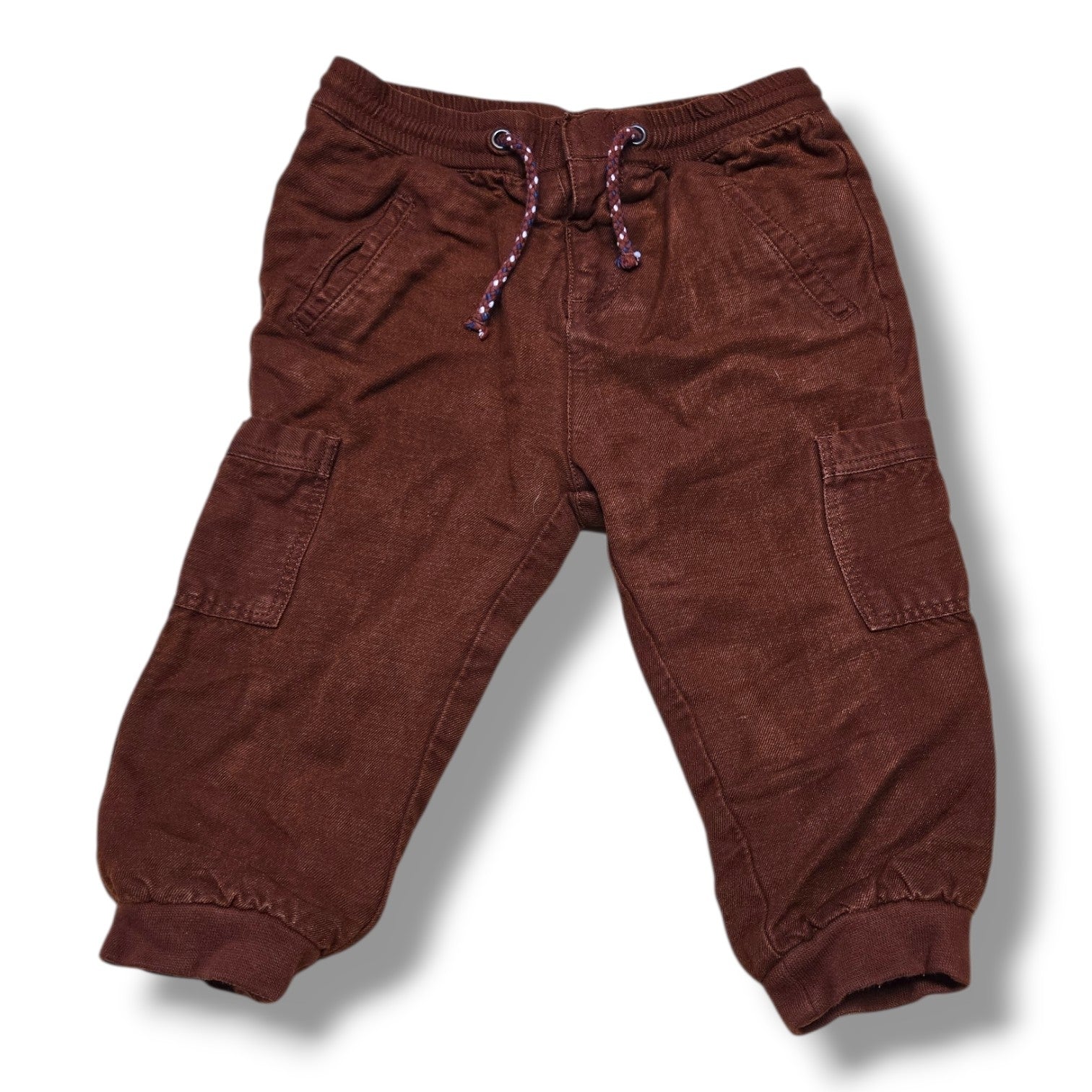 Stylish pre-loved Zara cargo joggers in rich rust brown color with elastic waistband and cuffed ankles.