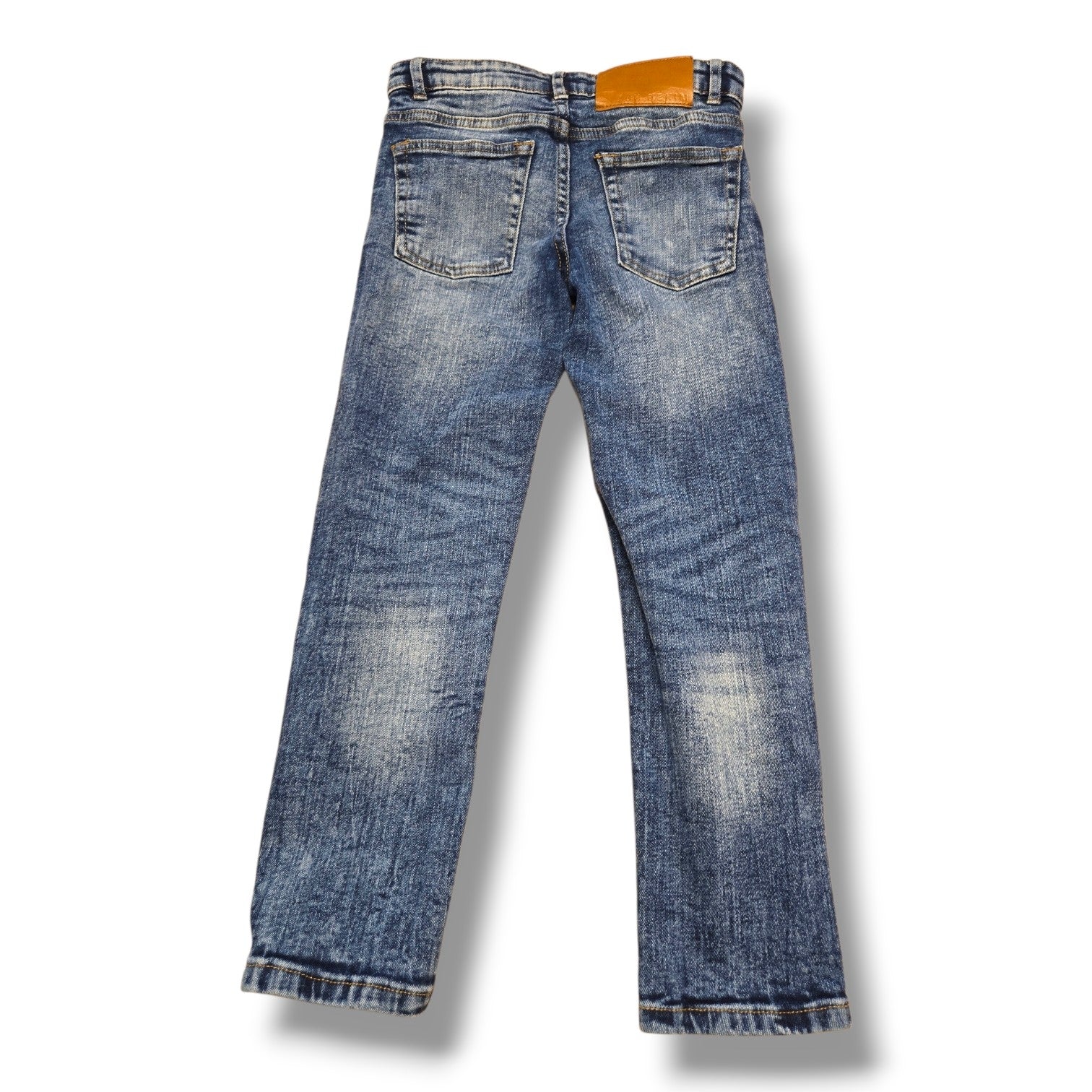 Back view of UH Denim pre-loved youth skinny jeans in medium wash, size 8, showcasing pockets and comfortable fit.