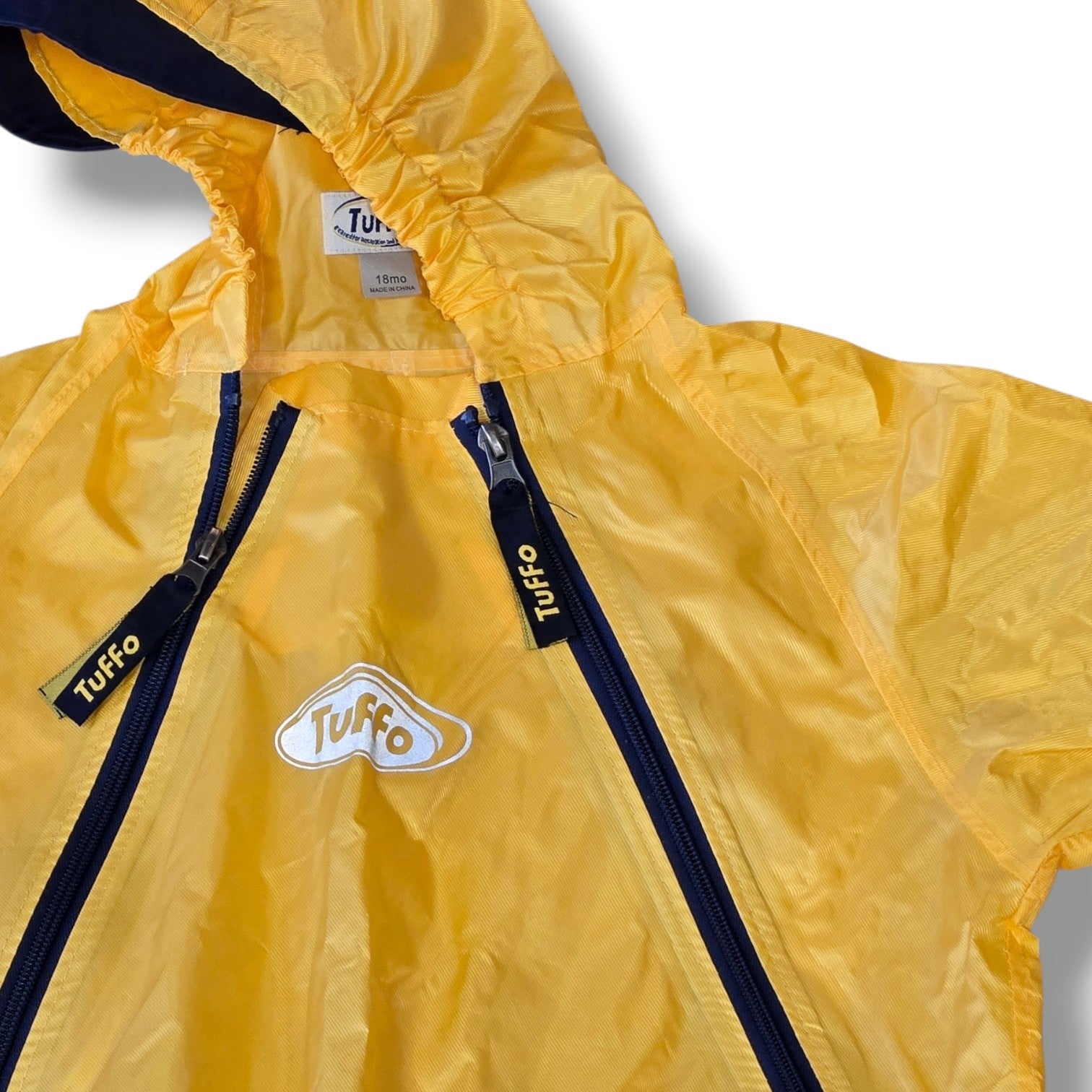 Pre-loved Tuffo waterproof rainsuit in bright yellow with navy accents, designed for outdoor adventures.
