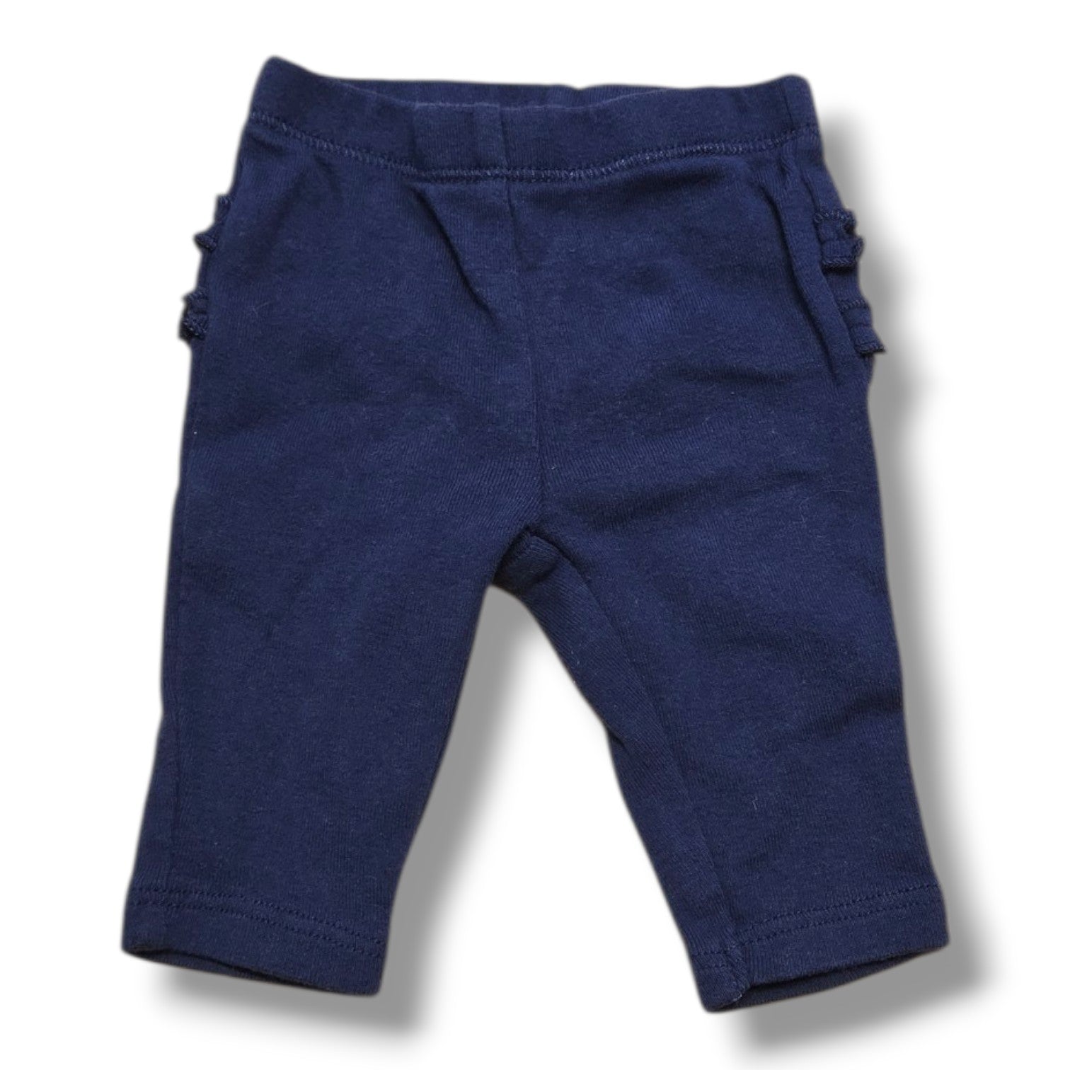Carter's newborn ruffle pants in soft navy with ruffle details, preloved quality, perfect for your little one.