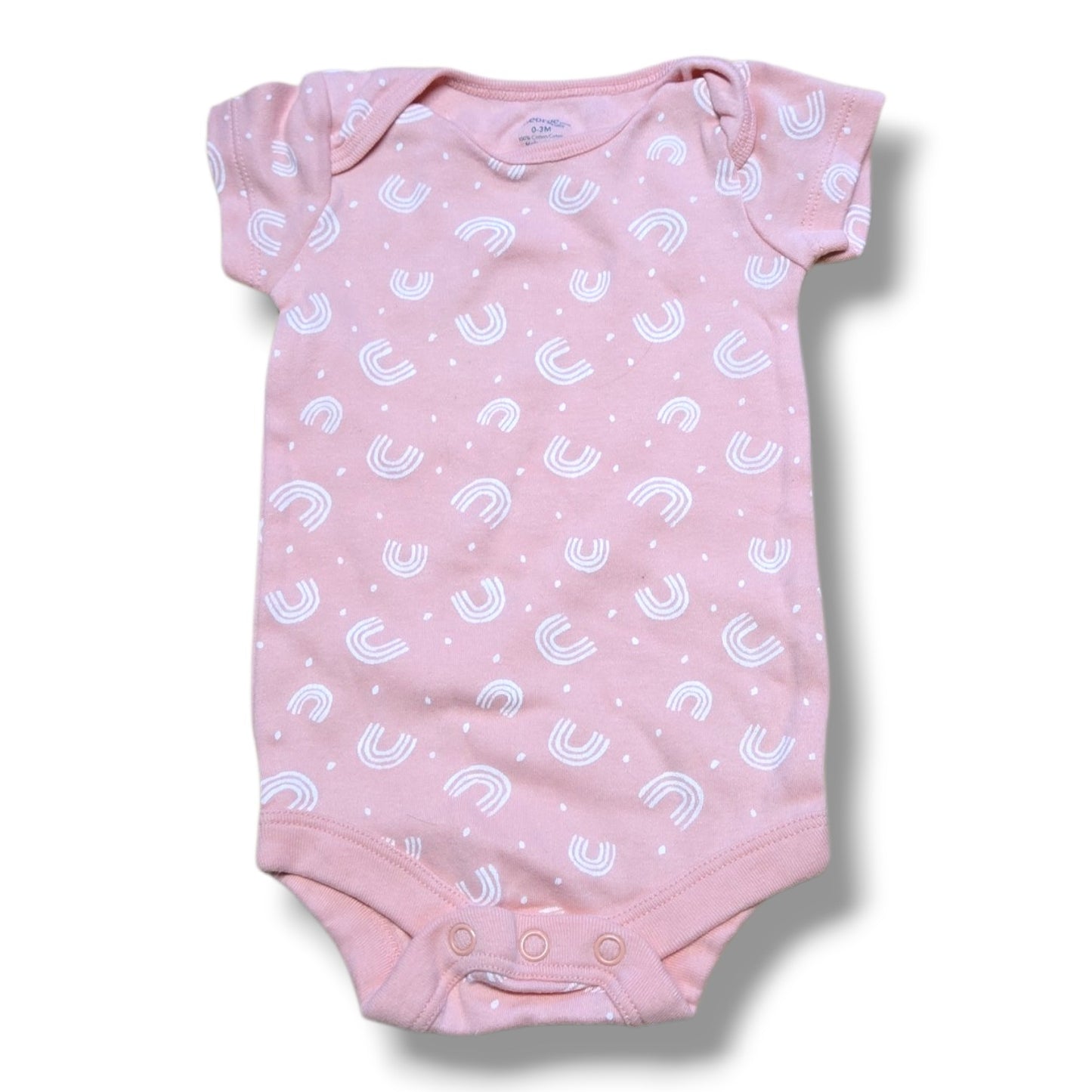 Pre-loved baby onesie in soft pink with white rainbow pattern and snap closures for easy changing.