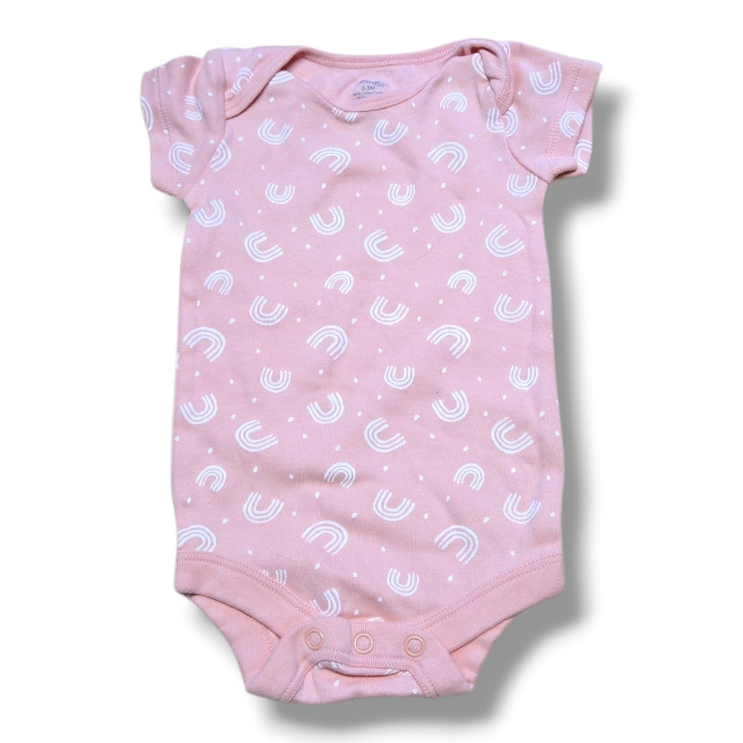 Pre-loved baby onesie in soft pink with white rainbow pattern and snap closures for easy changing.